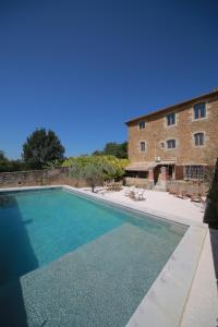 a large swimming pool in front of a building at Les Yourtes de Provence in Saint-Paulet-de-Caisson