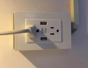 a white electrical outlet on a wall at N-square Hostel 任意宿背包客棧 in Yuanli
