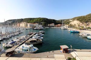 a bunch of boats are docked in a harbor at Superbe T3 sur la Marina de Bonifacio in Bonifacio