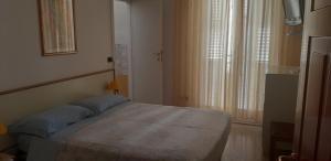 Postel nebo postele na pokoji v ubytování Hotel Galassi