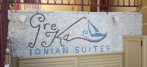 a sign that says go sailing suites on a wall at GreKa Ionian Suites in Agia Effimia