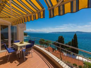 balcón con mesa, sillas y vistas al océano en Apartments Villa Vanda, en Selce