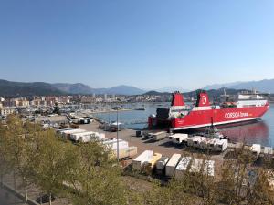 a large red boat is docked in a harbor at Hotel le Dauphin in Ajaccio