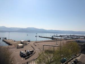 a parking lot next to a large body of water at Hotel le Dauphin in Ajaccio