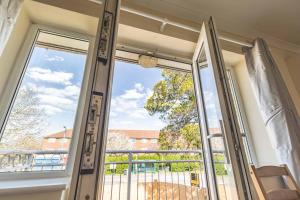 a glass door with a view of a balcony at Heathrow Apartment - private balcony & FREE PARKING! in Slough