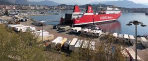 a large red boat is docked in a harbor at Hotel le Dauphin in Ajaccio