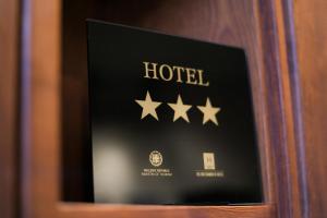 a sign for a hotel with four stars at Gastronomy Hotel Kritsa in Portaria