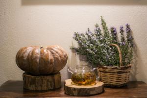 a table with a pumpkin and a basket of flowers at Gastronomy Hotel Kritsa in Portaria