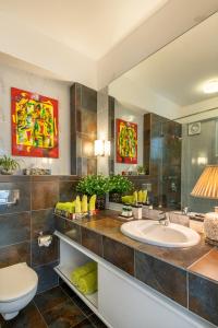 a bathroom with a sink and a toilet at La Mer Apartments in Nerul