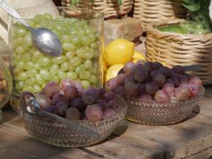 a bunch of grapes and other fruits in baskets at Gastronomy Hotel Kritsa in Portaria