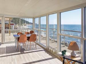 a dining room with a view of the ocean at Three-Bedroom Holiday home in Gørlev 7 in Rønne