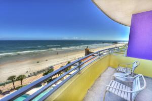 a balcony with two benches overlooking the beach at Wyndhams Ocean Walk Resort in Daytona Beach