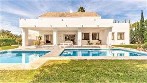 a villa with a swimming pool in front of a house at Villa Marina in Marbella