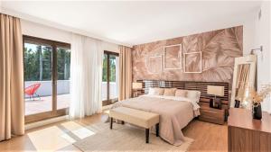 a bedroom with a large bed and a large window at Villa Marina in Marbella +37 photos