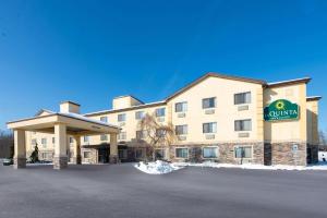 a hotel with a sign on the front of it at La Quinta by Wyndham Erie in Erie