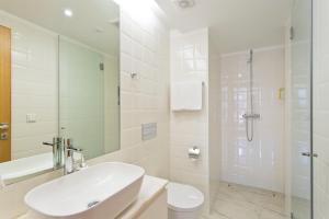 a white bathroom with a sink and a shower at OTF- Porto Centro in Porto +42 photos
