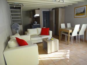 a living room with a white couch and red pillows at Condo Gardens Leuven in Leuven