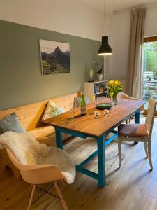 a dining room with a table and a couch at Privé sauna & terras - Aachen Vaals Drielandenpunt in Vaals
