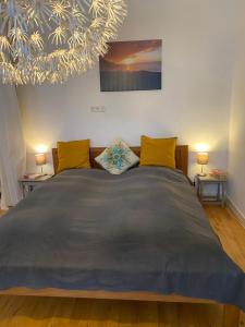 a bedroom with a large bed with yellow pillows at Privé sauna & terras - Aachen Vaals Drielandenpunt in Vaals