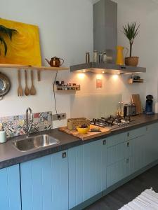 a kitchen with a sink and a counter top at Privé sauna & terras - Aachen Vaals Drielandenpunt in Vaals