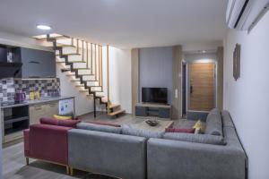 sala de estar con sofá y escalera en Elanis Suites, en Antalya