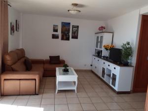 a living room with a couch and a table at ESQUINZO POOL & BEACH in Playa Jandia