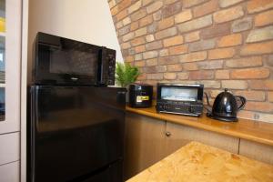a microwave sitting on top of a refrigerator in a kitchen at Premier suite Shinjuku okubo Tokyo 3F in Tokyo