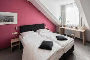 Postel nebo postele na pokoji v ubytování Hotel Aigner