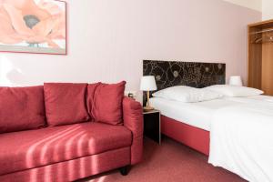 Postel nebo postele na pokoji v ubytování Hotel Aigner