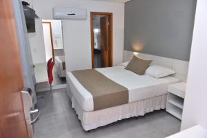 Voodi või voodid majutusasutuse Hotel Três Caravelas toas