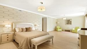 a bedroom with a bed and a room with chairs at Villa Marina in Marbella