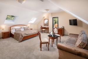a bedroom with a bed and a living room at Hotel Cvita in Split