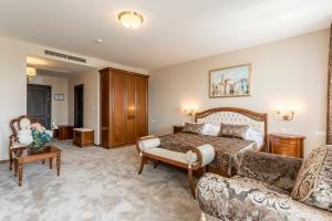 a hotel room with a bed and a couch at Hotel Cvita in Split