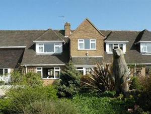 a statue of a bear in front of a house at Mather House Retreat in Wantage