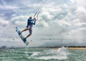 a man on a surfboard in the water at High Flyers Kite House in Tarifa