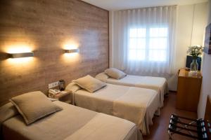 מיטה או מיטות בחדר ב-Hotel Nadal