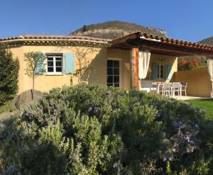 a house with a garden in front of it at Pays des Senteurs in Saint-Ferréol-Trente-Pas