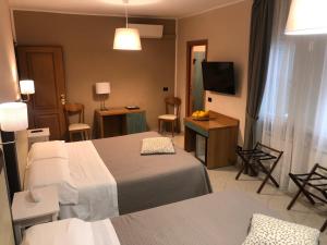 Posteľ alebo postele v izbe v ubytovaní Hotel Di Stefano