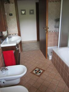 a bathroom with a toilet and a sink and a shower at Appartamento Sopramonte in Trento