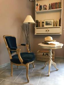 a room with a chair and a table with a lamp at Pays des Senteurs in Saint-Ferréol-Trente-Pas