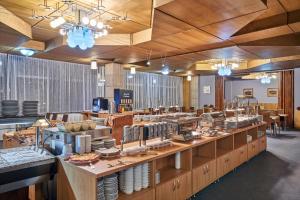 a large kitchen with a buffet of food on display at Hotel Horizont in Pec pod Sněžkou