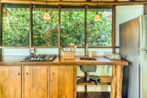 a kitchen with a wooden counter top and a refrigerator at El Ballenato de Bahia #2 in Uvita +34 photos