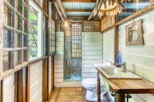 a bathroom with a toilet and a sink at El Ballenato de Bahia #2 in Uvita