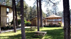 a park with picnic tables and a gazebo at Village Lodge in Ruidoso