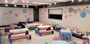 Mobil home proche du paradis des plages في سان جان دي مونت: غرفة مع طاولة وكراسي وغرفة لعب