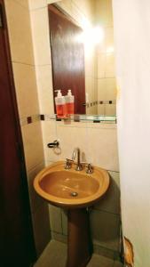 a bathroom with a sink and a mirror at La Valentina in Purmamarca