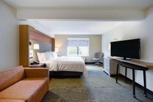 a hotel room with a bed and a flat screen tv at Holiday Inn Allentown-Bethlehem by IHG in Allentown