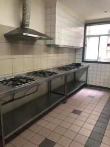 a kitchen with a bunch of stove tops in it at Elizabeth Hostel in Melbourne