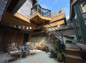 a balcony with a table and chairs on a house at Ho Feng Private Hotel 電梯自助民宿 in Ji'an