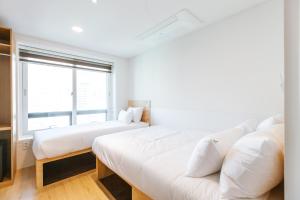 Ein Bett oder Betten in einem Zimmer der Unterkunft Step Inn Myeongdong 1
